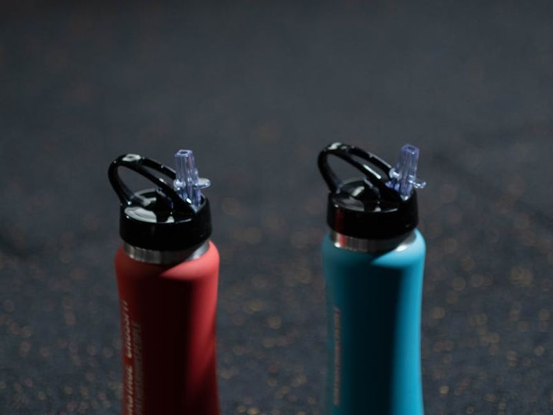 Close up of sports equipment and water bottle on gym floor